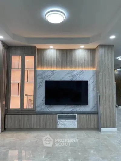 Modern living room with elegant TV wall unit and ambient lighting