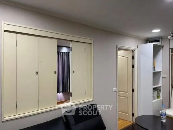 Modern living room with sleek furniture and built-in storage solutions.