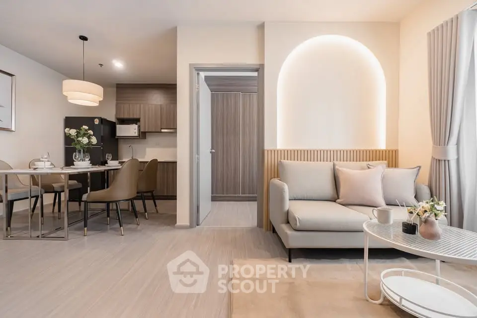 Modern open-plan living room with elegant dining area and stylish decor.