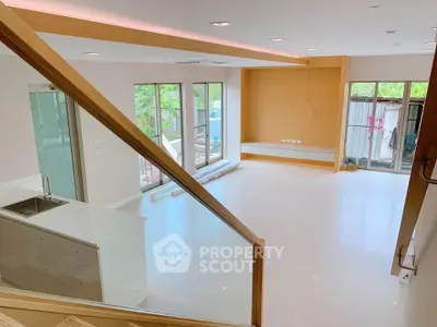 Spacious modern living room with open kitchen and large windows