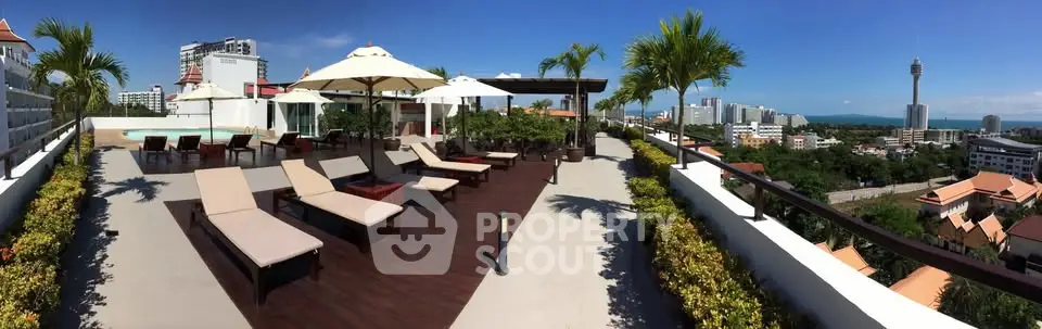 Stunning rooftop terrace with panoramic city views and luxurious lounge chairs.