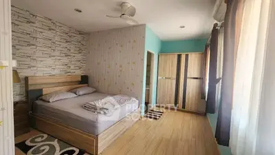 Spacious bedroom with modern decor and ample natural light