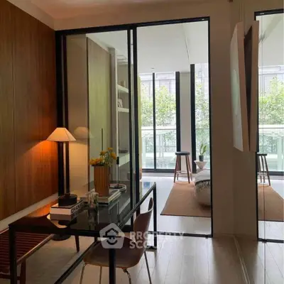 Modern study area with glass doors leading to a spacious balcony.