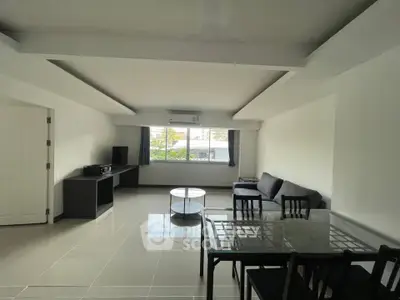 Spacious living room with modern furniture and large windows offering natural light.