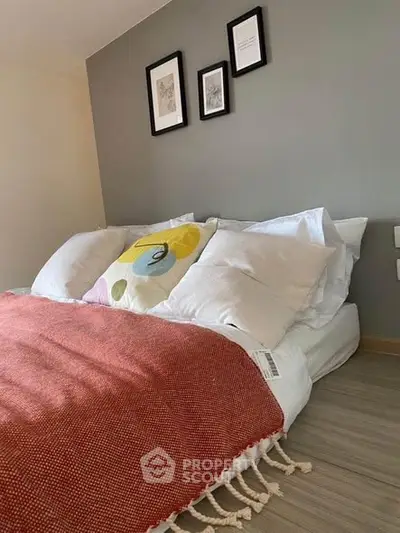 Cozy bedroom with modern decor and stylish wall art, perfect for relaxation.