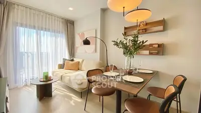 Modern living room with dining area, stylish decor, and natural light.