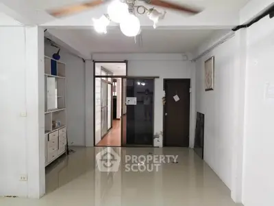 Spacious interior with glossy floors and modern lighting, ideal for versatile living space.