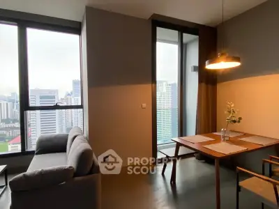 Modern living room with city view and stylish dining area in high-rise apartment.