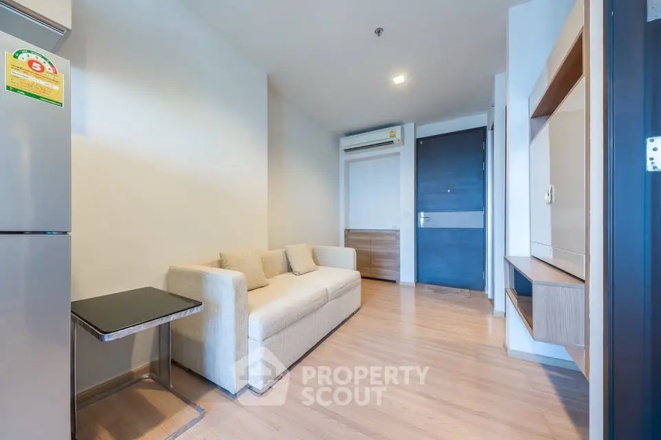 Modern living room with beige sofa and sleek wooden flooring