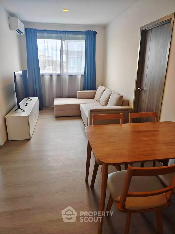 Cozy living room with modern furniture and natural light, perfect for relaxation and entertainment.