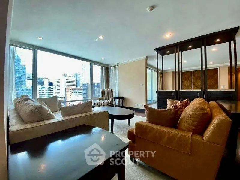 Spacious living room with city view, modern furniture, and large windows in a high-rise apartment.