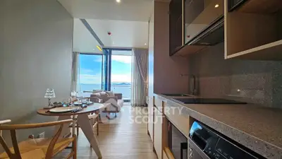 Modern open-layout kitchen and living room with stunning ocean view