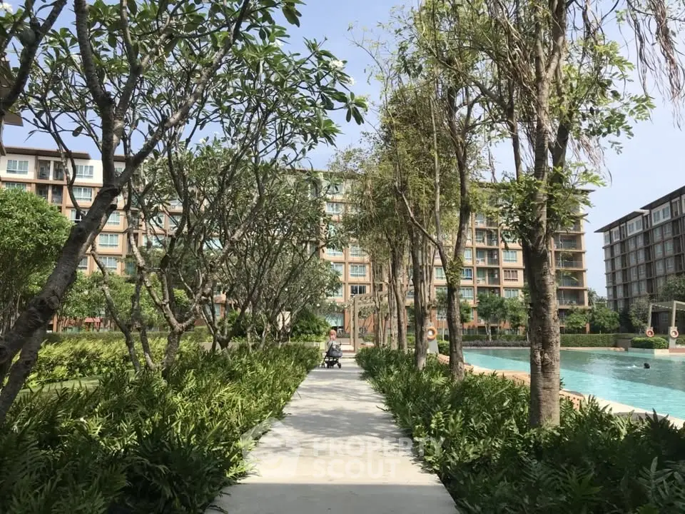 Luxurious residential complex with lush gardens and inviting pool area, perfect for modern living.
