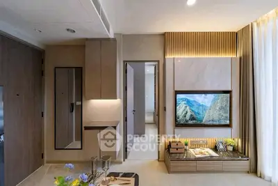 Modern living room with stylish decor and built-in TV unit, showcasing elegant interior design.