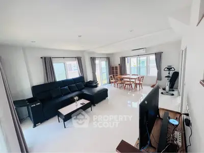 Spacious modern living room with sleek furniture and abundant natural light