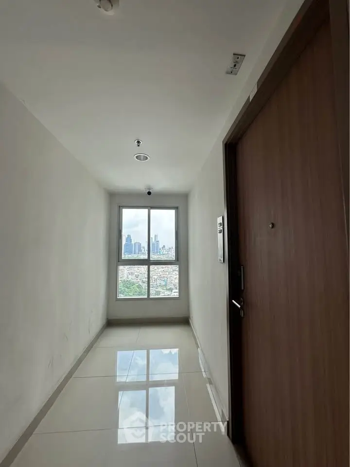 Modern apartment corridor with city view through window