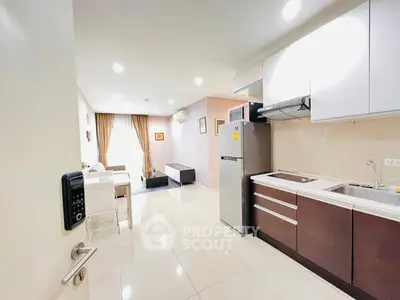 Modern open-plan kitchen and living room with sleek appliances and stylish decor.