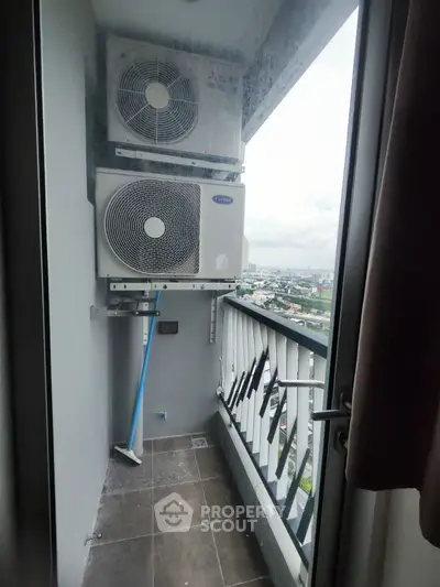 Compact balcony with air conditioning units and city view, ideal for urban living.