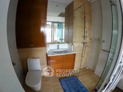 Modern bathroom with glass shower and wooden cabinetry