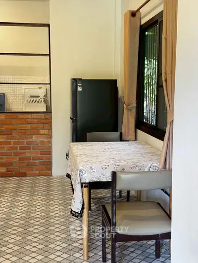 Charming kitchen with brick accents and cozy dining area, perfect for intimate meals.