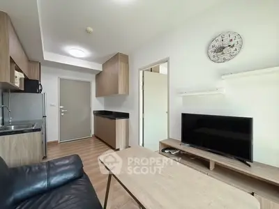 Modern living room with sleek furniture and open kitchen layout