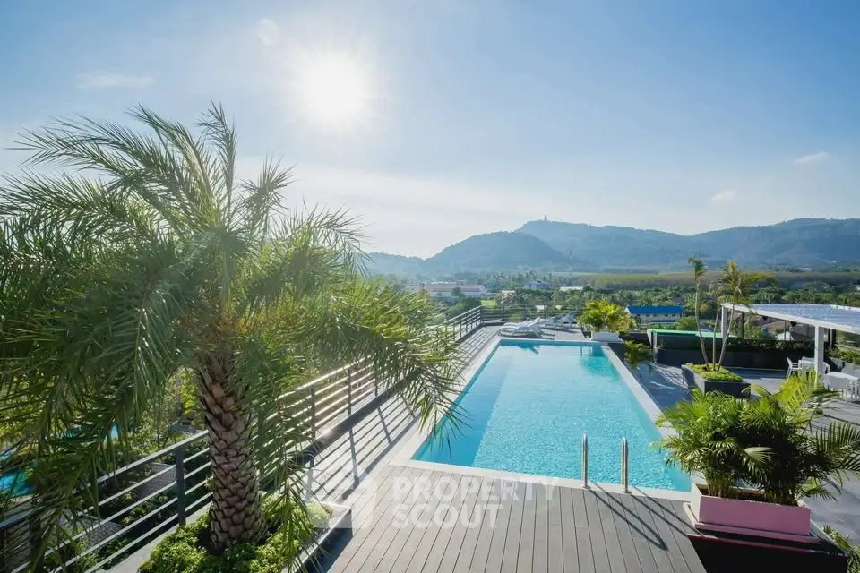 Stunning rooftop pool with panoramic mountain views and lush greenery.