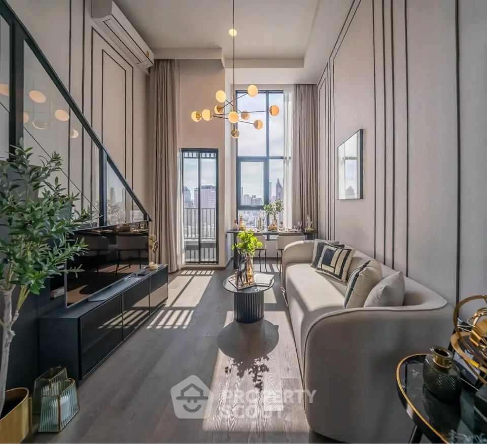 Luxurious modern living room with high ceilings and city view, featuring elegant decor and ample natural light.