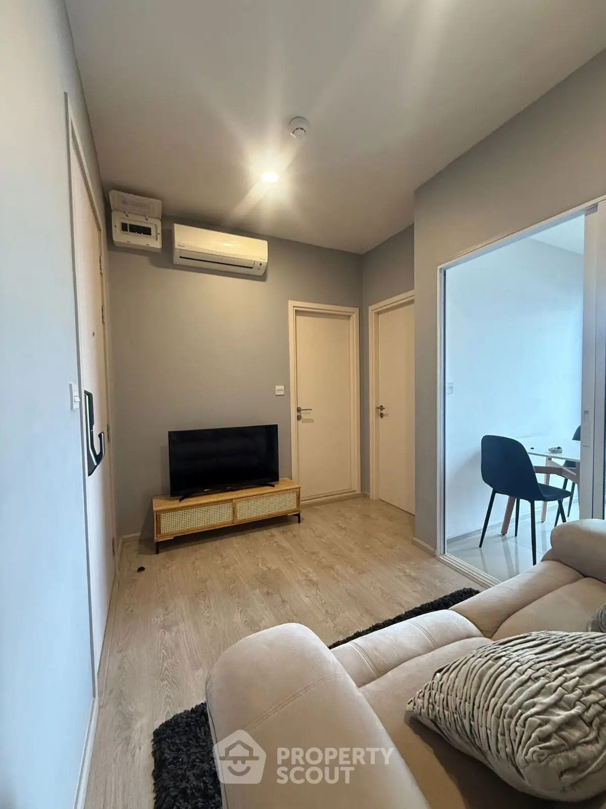 Cozy living room with modern decor and air conditioning, perfect for relaxation.