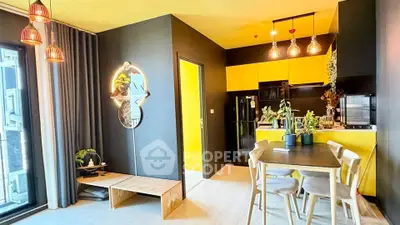 Modern open-layout kitchen and dining area with vibrant yellow accents and stylish lighting.