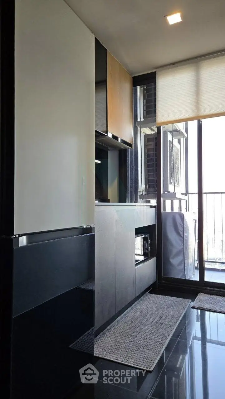 Modern kitchen with sleek cabinets and balcony view