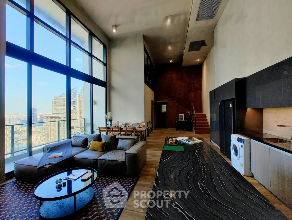 Luxurious modern living room with stunning city view and open kitchen layout.