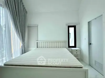 Bright and airy bedroom with large windows and minimalist decor