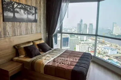 Luxurious bedroom with stunning city view and modern decor in high-rise apartment.