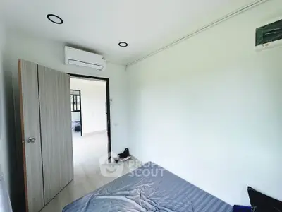 Bright bedroom with air conditioning and open door to hallway, showcasing modern minimalist design.
