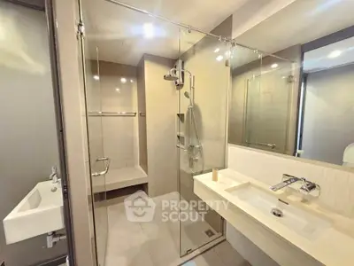 Modern bathroom with glass shower and sleek fixtures