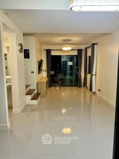 Spacious modern living room with glossy floors and elegant lighting