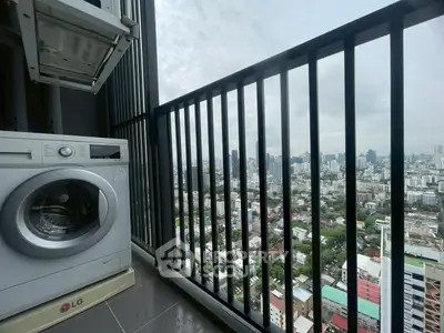 High-rise balcony with washing machine and stunning cityscape view