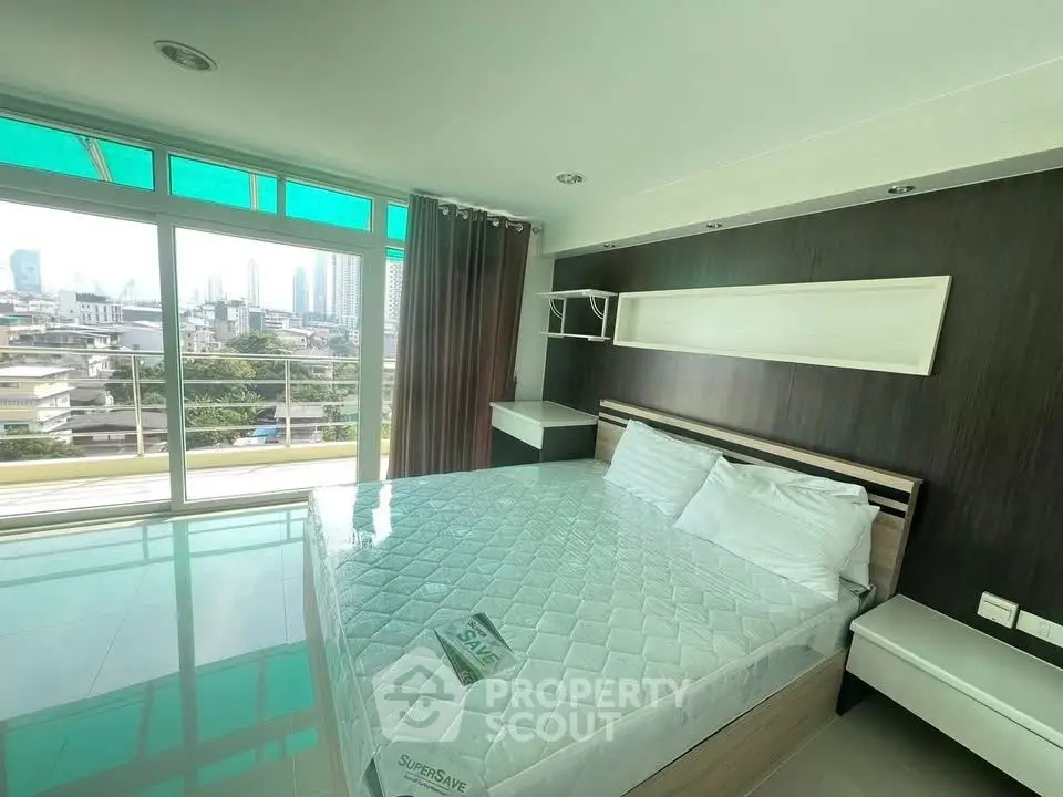 Spacious bedroom with city view and modern furnishings