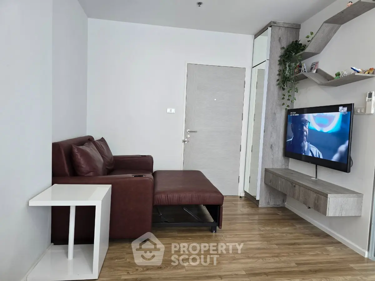 Modern living room with sleek furniture and mounted TV, perfect for cozy relaxation.