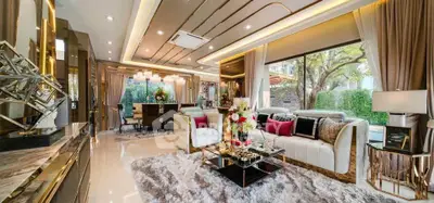 Luxurious living room with elegant decor and large windows offering garden views.