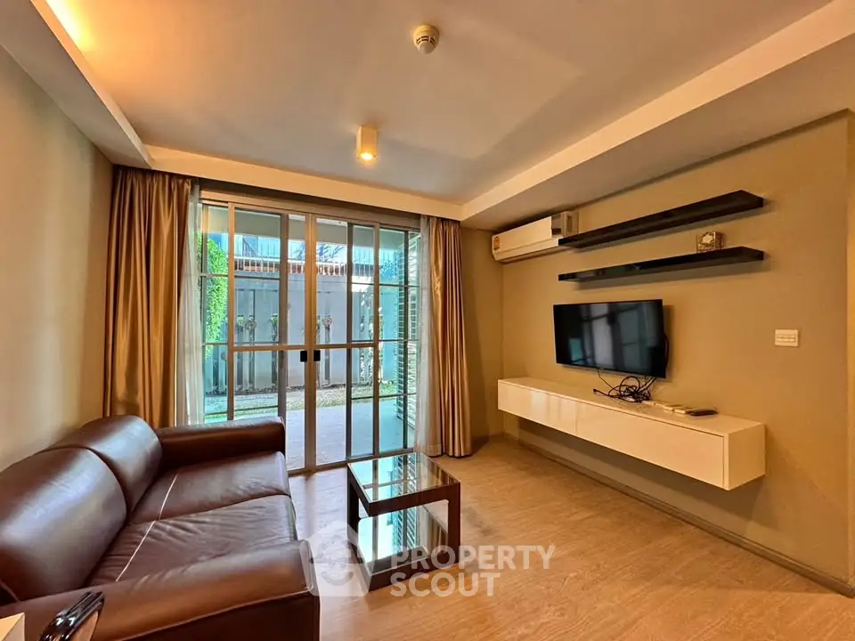 Modern living room with sleek furniture and large windows offering natural light.