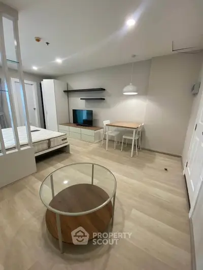 Modern studio apartment with open layout, featuring a cozy living area and stylish furnishings.