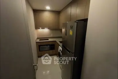 Modern compact kitchen with sleek cabinetry and integrated appliances