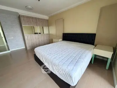 Spacious bedroom with modern design and large bed in a stylish apartment.