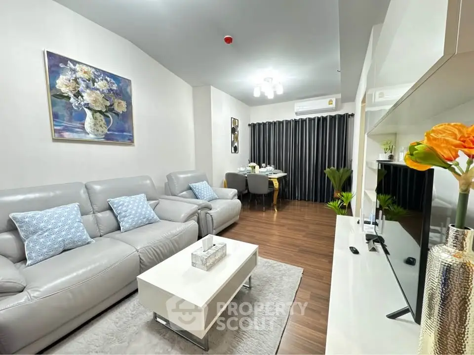 Modern living room with elegant decor, featuring plush sofas, a sleek coffee table, and a stylish dining area.
