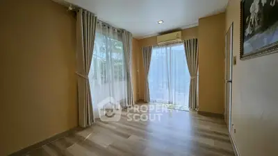 Spacious empty room with large windows and elegant curtains, perfect for customization.