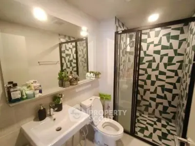 Modern bathroom with geometric shower tiles and sleek fixtures