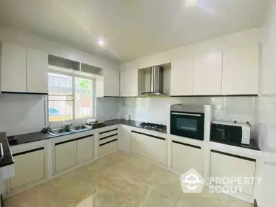 Modern kitchen with sleek cabinetry and built-in appliances, featuring a gas stove and ample counter space.