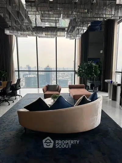 Luxurious living room with panoramic city view and elegant furnishings.