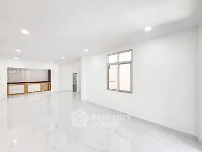 Spacious modern interior with sleek flooring and open layout, ideal for customization.